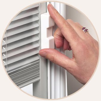 Hand adjusting magnetic slider for between-the-glass blinds on a patio door