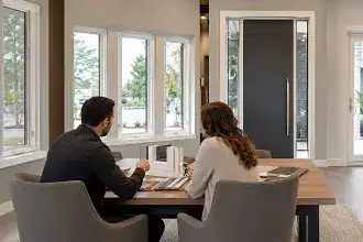 Omega specialist reviewing window and door project details with homeowners and project teams.